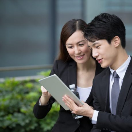 Business man and woman discuss about the financial plan on digital tablet